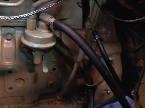1990 Ford Bronco - Close-up of a fuel pump and associated hoses within an engine bay, likely part of a diesel swap.