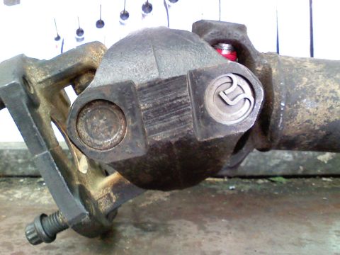 1990 Ford Bronco - A close-up view of a vehicle's driveshaft U-joint, showing its mechanical components.