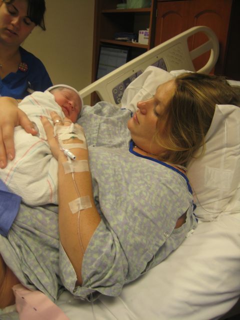 2008 Ford F-250 - New mother cradles her newborn baby shortly after birth in a hospital room.
