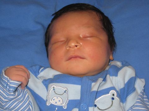 2008 Ford F-250 - A close-up of a baby's face as they sleep peacefully, dressed in comfortable striped pajamas.