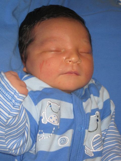 2008 Ford F-250 - Newborn baby sleeping peacefully in blue striped pajamas adorned with frog graphics.