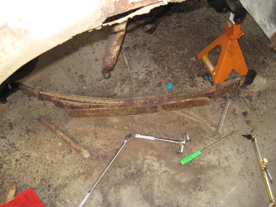 Leaf spring and shock absorber with tools and jack stand