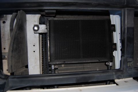 1994 Ford Bronco - Close-up view of a transmission cooler and auxiliary filter assembly, likely installed in the front grille area of a vehicle.