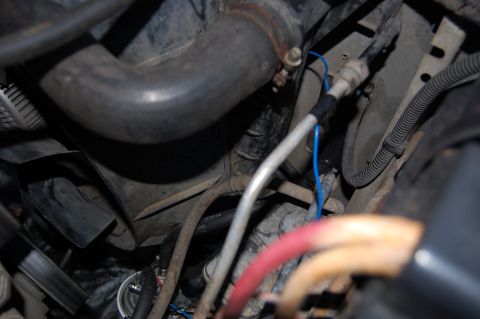 1994 Ford Bronco - Hoses entering engine bay through existing hole in core support. Trans temp signal wire also visible. (temporary routing)