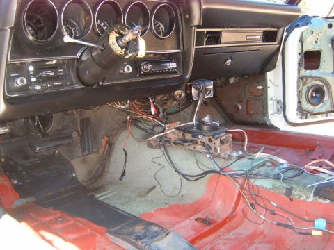 1973 Ford Ranchero - The interior of a 1973 Ford Ranchero shows significant disassembly with exposed wiring and a removed dashboard.