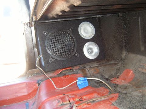 1973 Ford Ranchero - Aftermarket speaker box with a woofer and two tweeters installed in the bed of a red pickup truck.