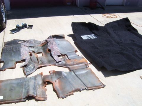 1973 Ford Ranchero - Car interior carpet and insulation removed and laid out on a concrete surface.
