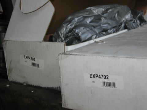 1986 Ford Bronco - Boxes labeled EXP4702, likely containing automotive parts, are shown.