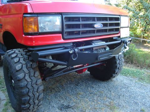 1989 Ford Bronco - Front view of a 1989 Ford Bronco showing its grille, headlights, and custom bumper with winch.