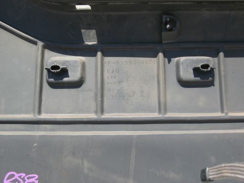 1986 Ford Bronco - A black plastic automotive part displays embossed text and mounting points.