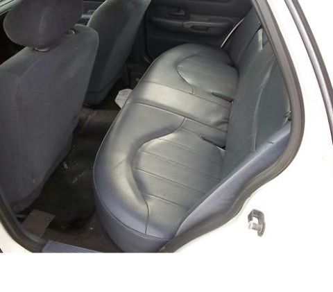1999 Ford Crown Victoria - Interior view of the rear seats and floor of a vehicle, with a watermark present.