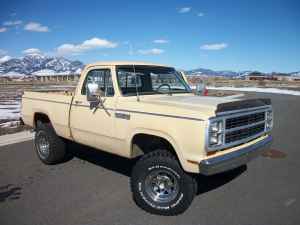 2006 Ford E350 - Small three-quarter front shot of a tan square-body Dodge 4x4 short-bed pickup with a black hood deflector, chrome grille and bumper, and c…