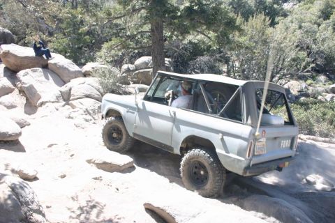 1991 Ford Bronco - This classic Ford Bronco navigates a challenging off-road course with rocky terrain.