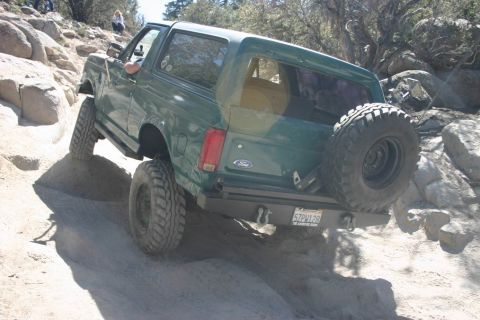 1991 Ford Bronco - This 1991 Ford Bronco navigates a challenging off-road trail with steep inclines and rocky terrain.
