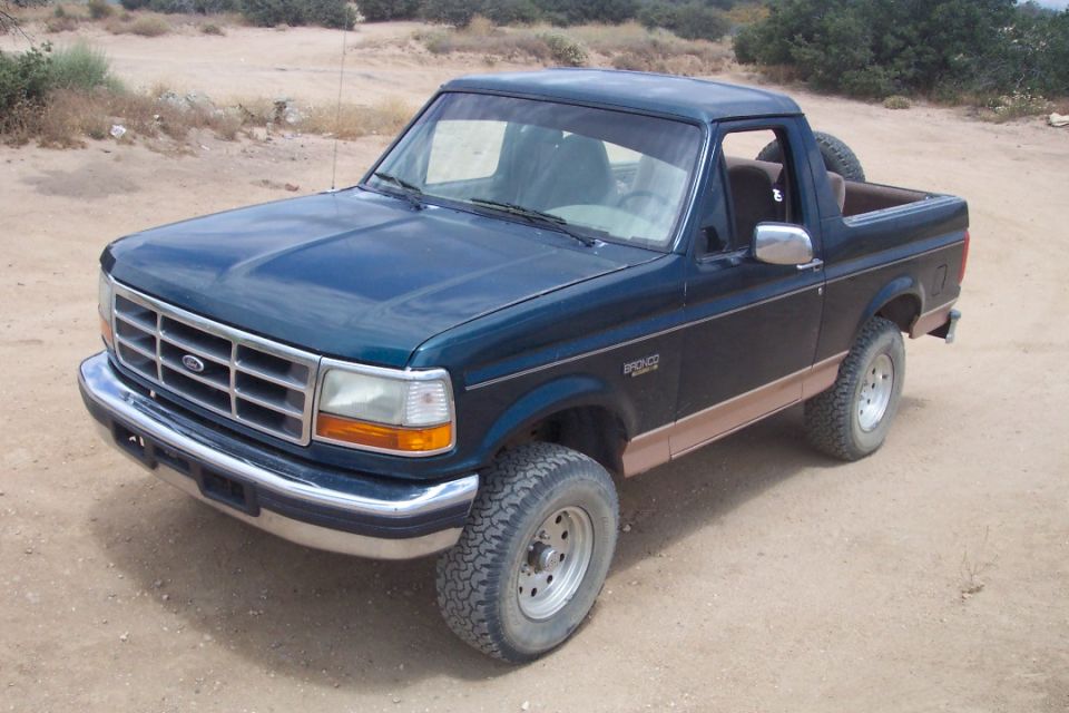 1995 Ford Bronco parked on dirt road