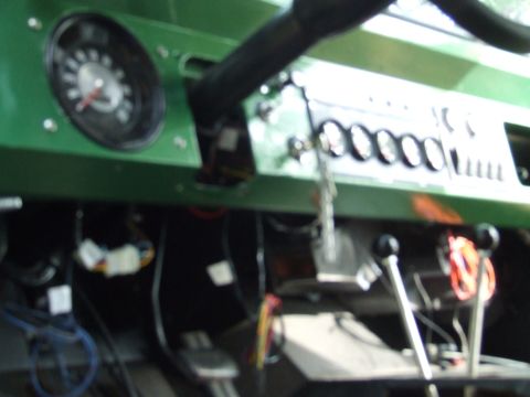 1976 Ford Bronco - The interior of a 1976 Ford Bronco shows the dashboard with multiple gauges and gear shifters.