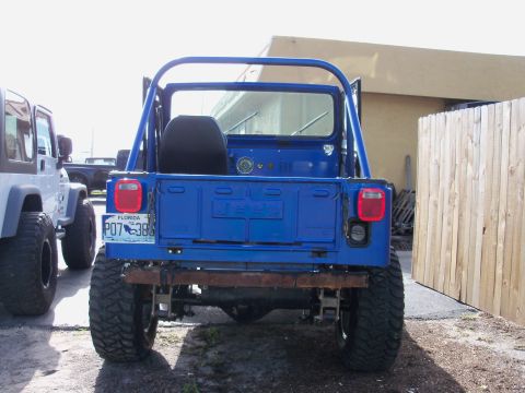 1978 Jeep CJ5 - Rear view of a blue 1978 Jeep CJ5, showing its distinctive body style and Florida license plate.