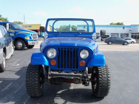 1978 Jeep CJ5 - Front view of a blue 1978 Jeep CJ5 parked in a lot with other vehicles.
