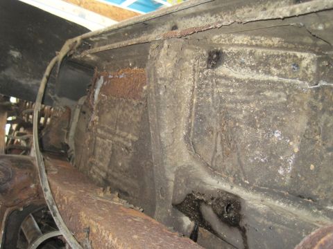 1979 Ford Bronco - The severely corroded undercarriage of a vehicle shows extensive rust and damage to the frame.