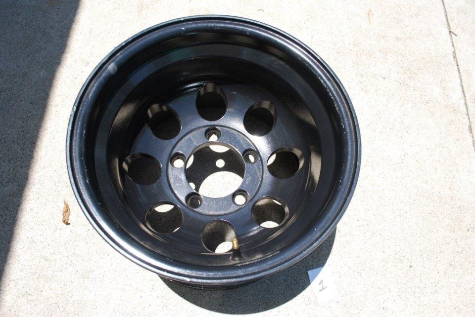 Black steel wheel with 5 pairs of circular cutouts