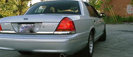 Rear quarter view of a silver 2000 Ford Crown Victoria parked outdoors