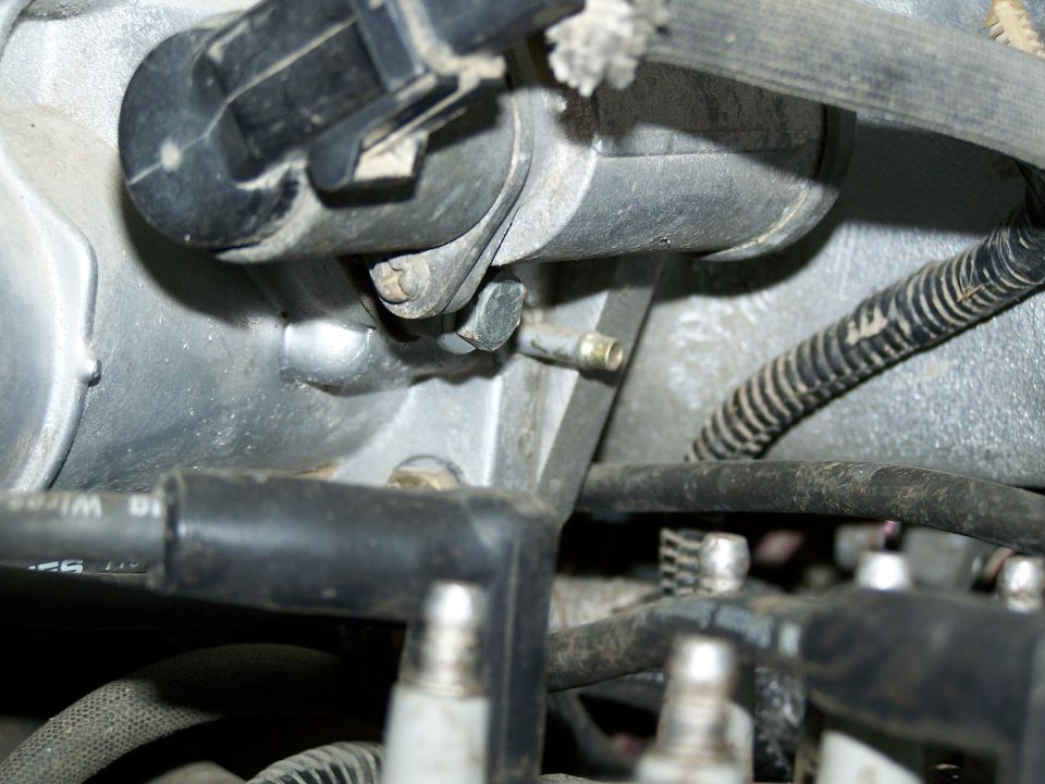 Close-up of engine parts, including spark plug wires and a metal manifold