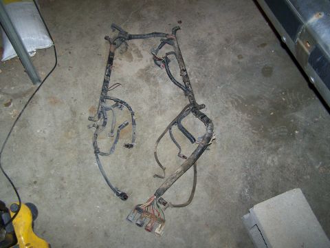 1989 Ford Bronco - A vehicle wiring harness is shown on a concrete floor, possibly for a Ford Bronco.
