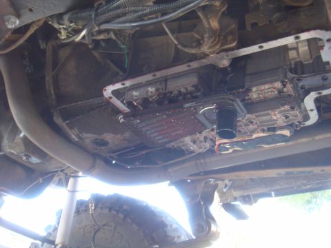 Transmission pan and filter removed, showing fluid and internal components