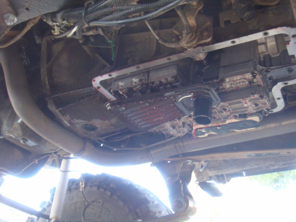 Transmission pan and filter removed, showing fluid and internal components