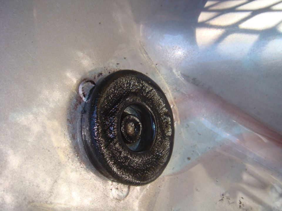 Black rubber grommet with bolt head, close-up view