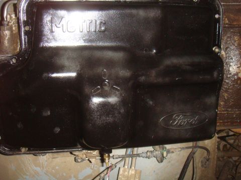 Black Ford transmission pan with "Metric" embossed on top