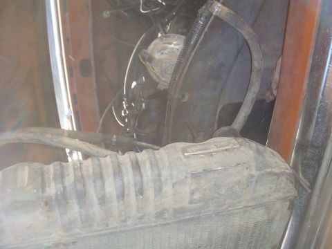Engine bay with radiator and hoses visible
