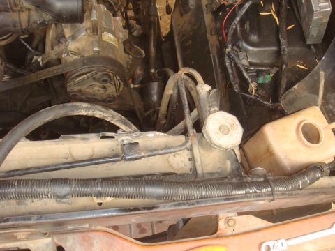 1992 Ford Bronco engine compartment with air conditioning compressor, radiator, and coolant reservoir