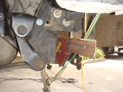 Trailer hitch bracket with wiring harness attached to frame