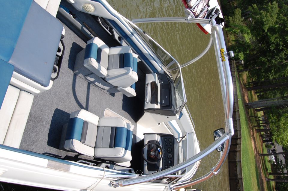 1988 Sea Ray Sundancer 268 interior with blue and gray seats and dashboard