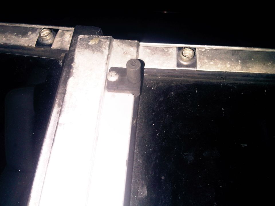 Metal frame with screws and a black surface, close-up view