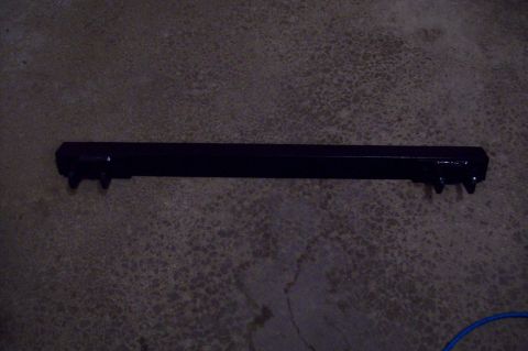 2006 Ford Fusion - A black tow bar is shown lying on a concrete surface.