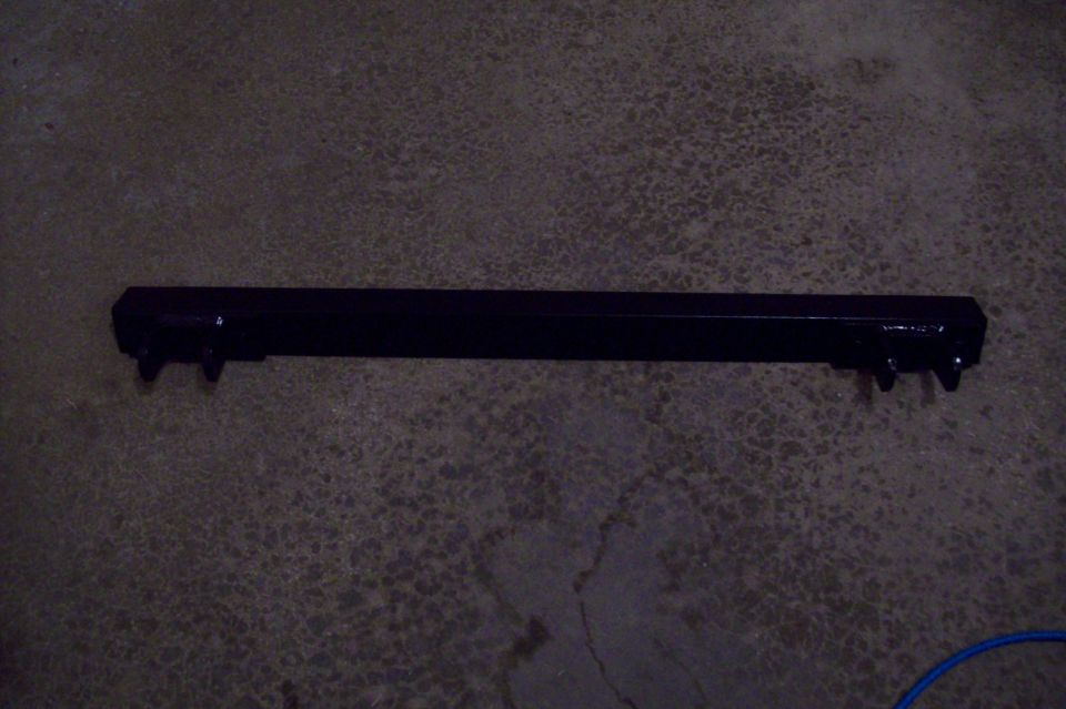 black tow bar with four bolts sticking out