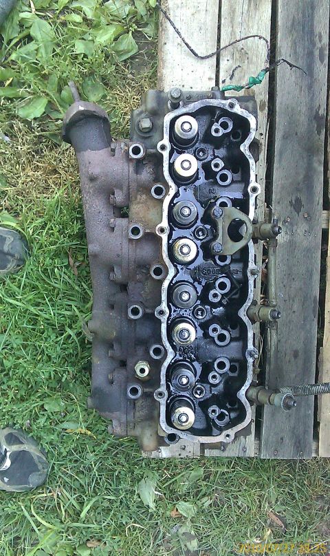 1985 Ford F-150 - Close-up of an engine cylinder head, showing internal components and exhaust manifold.