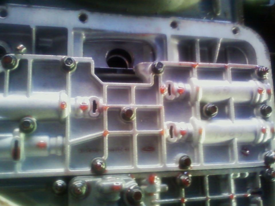 Automatic transmission valve body casting with bolts and orange marks