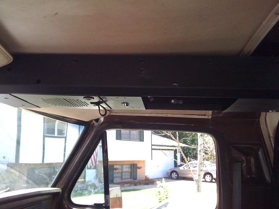 Fabricated overhead console shelf mounted to truck cab roof with dome light and wiring