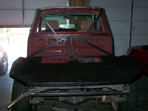1988 Suzuki Samurai - Custom rear cage and bumper installed on a red pickup truck.