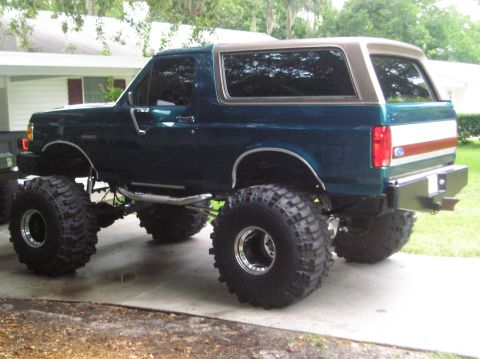 1978 Ford Bronco - This lifted Ford Bronco features oversized tires and a two-tone paint scheme with a tan roof.