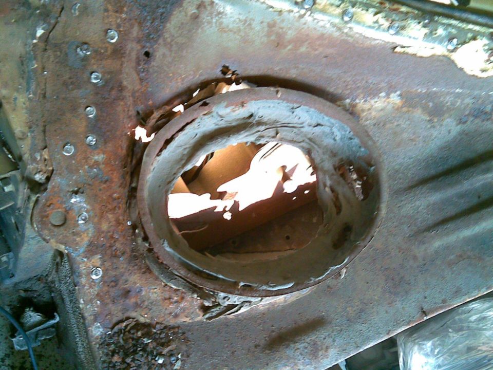 with the top cowl panel removed we can see the remains of an earlier attempt to seal the fresh air intake, it worked for a while, until the rest of the car crumbled around the schmoo
