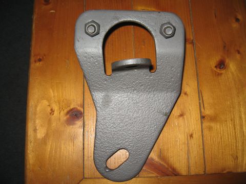 1968 Shelby GT500 - A single gray metal tie down bracket is shown against a wooden background.
