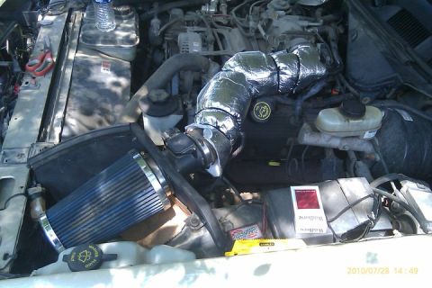 2000 Mercury Grand Marquis - Aftermarket cold air intake installed in the engine bay. Other items are visible on top of engine components.