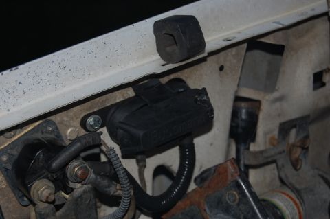 1994 Ford Bronco - should've checked for clearance first. The hood hinge hit the fuse holder when the hood was closed, causing this damage.