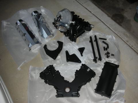 1992 Ford Crown Victoria - Engine parts laid out on plastic sheeting, likely for a rebuild or upgrade project.