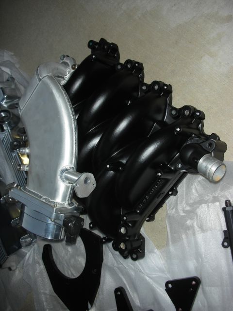 1992 Ford Crown Victoria - Aftermarket intake manifold and associated parts laid out.