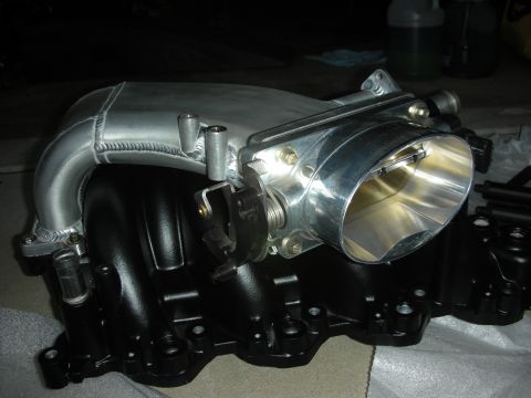 1992 Ford Crown Victoria - Close-up of an aftermarket intake manifold and throttle body assembly, likely for engine performance modification.